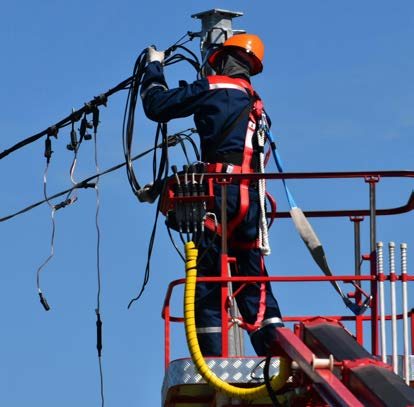 Technician working on overhead lines