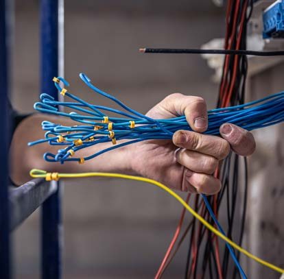 Technician terminating telecommunications cabling