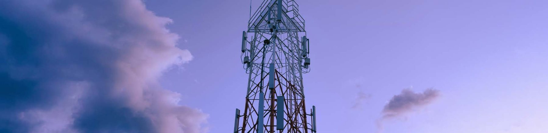 Telecommunications tower against a dusk sky